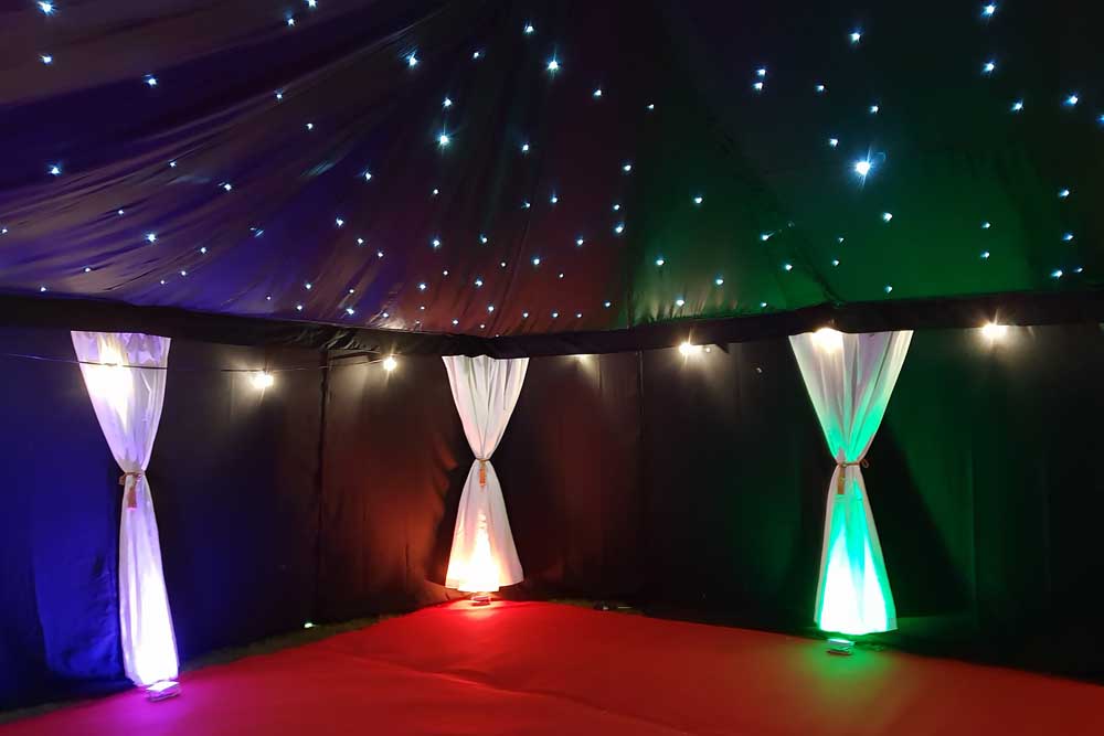 A 9x6m Night Club Marquee with Red Carpet and colourful RGB LED Uplights.