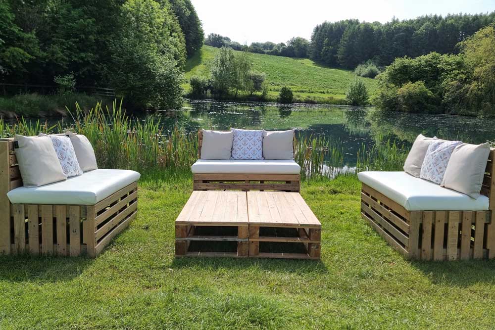 Three pallet benches in idyllic lakeside garden