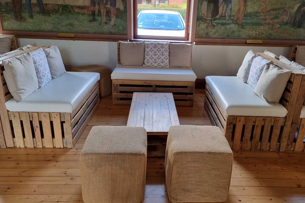Pallet Benches, Coffee Tables, and Hessian Cubed Pouffes Inside a Village Hall
