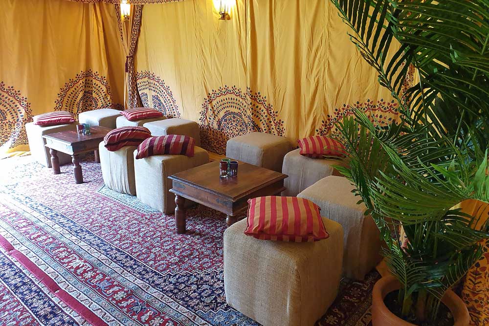 Hessian Cubed Pouffes Inside a Bedouin Tent with Saffron Linings and Burgundy Persian Carpets