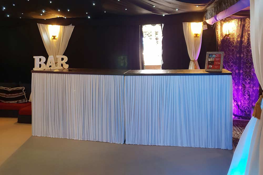 Two Wooden Bar Units Decorated with a Bright White Pleated Cover - 40th Birthday Party
